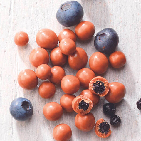 ROYCE' Chocolate - Blueberry Chocolate - Image shows blueberries and chocolate-coated berries with white wooden background