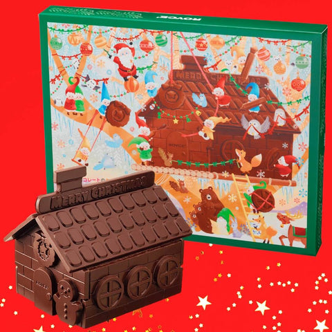 Chocolate No I-E - Image shows a printed box with illustration of a chocolate house with animals and dwarves. Also seen is a chocolate house in brown. Background is in red.