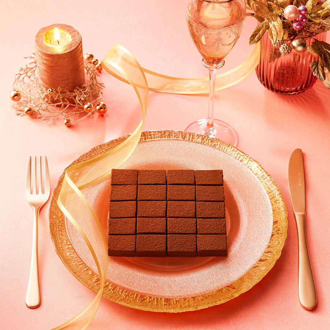 ROYCE' Prestige Nama Chocolate Collection - Image shows chocolate blocks on a plate with golden utensils.