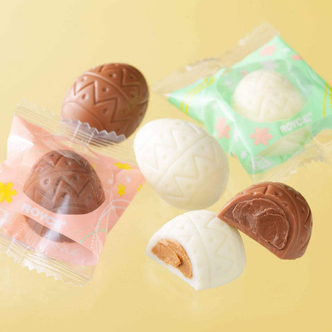 Image shows brown and white chocolate eggs with wrapper.