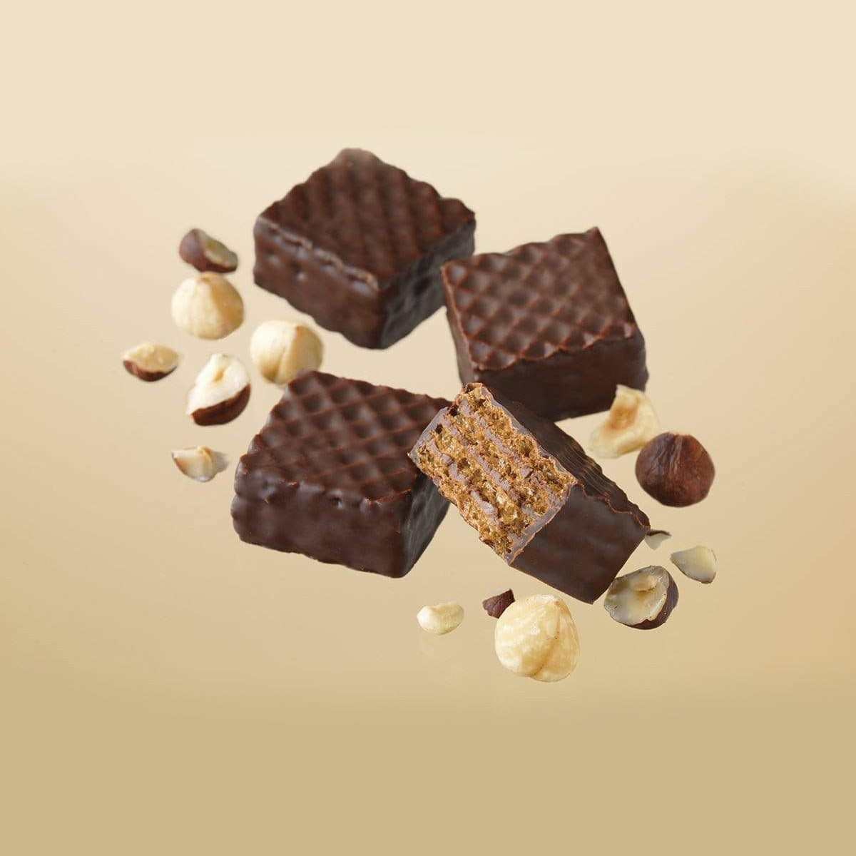 ROYCE' Chocolate - Chocolate Wafers "Hazel Cream" - Image shows brown chocolate wafers with a crisscrossed texture and accents of hazelnuts. Background is in light brown.